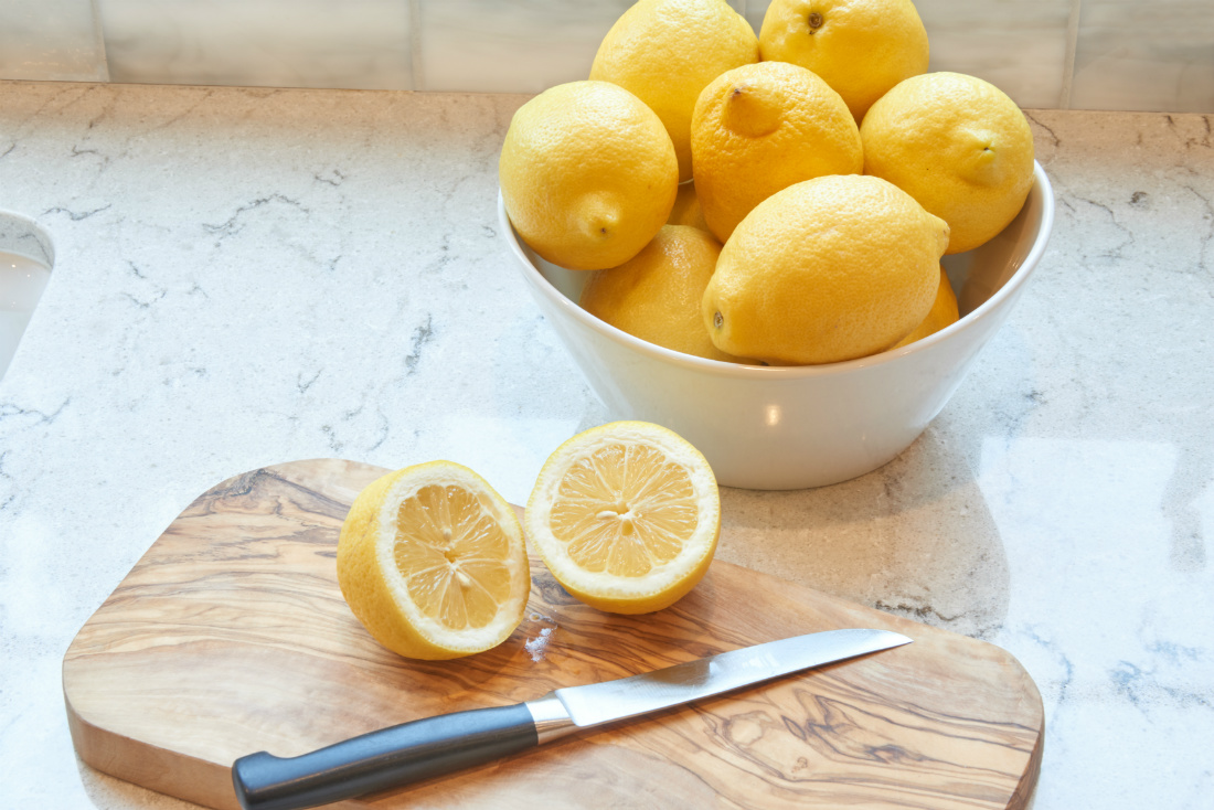 fresh-cut-lemons-on-a-wooden-cutting-board-with-knife