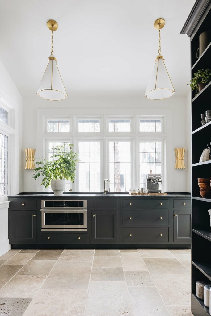 scullery with oven and sink, large windows and pendants