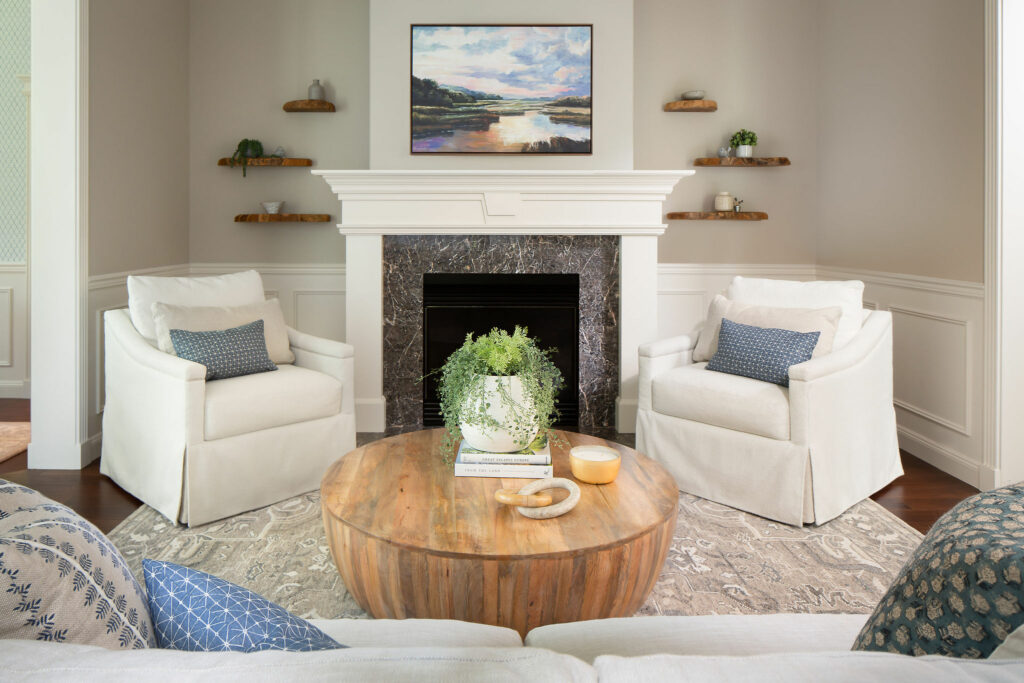Living room rug with two accent chairs in front of fireplace