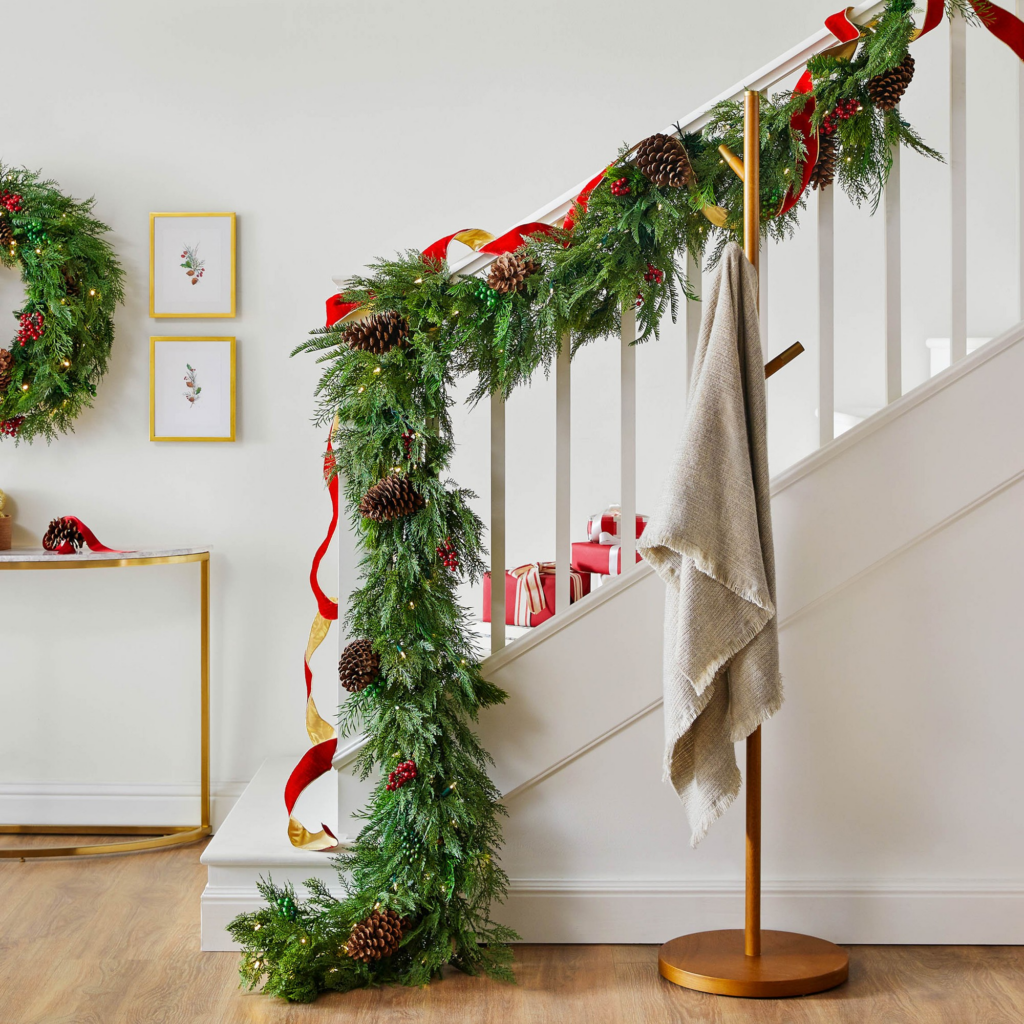 Christmas staircase decor, hanging garland and red velvet ribbon