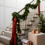 Christmas staircase decor, hanging garland and red velvet ribbon