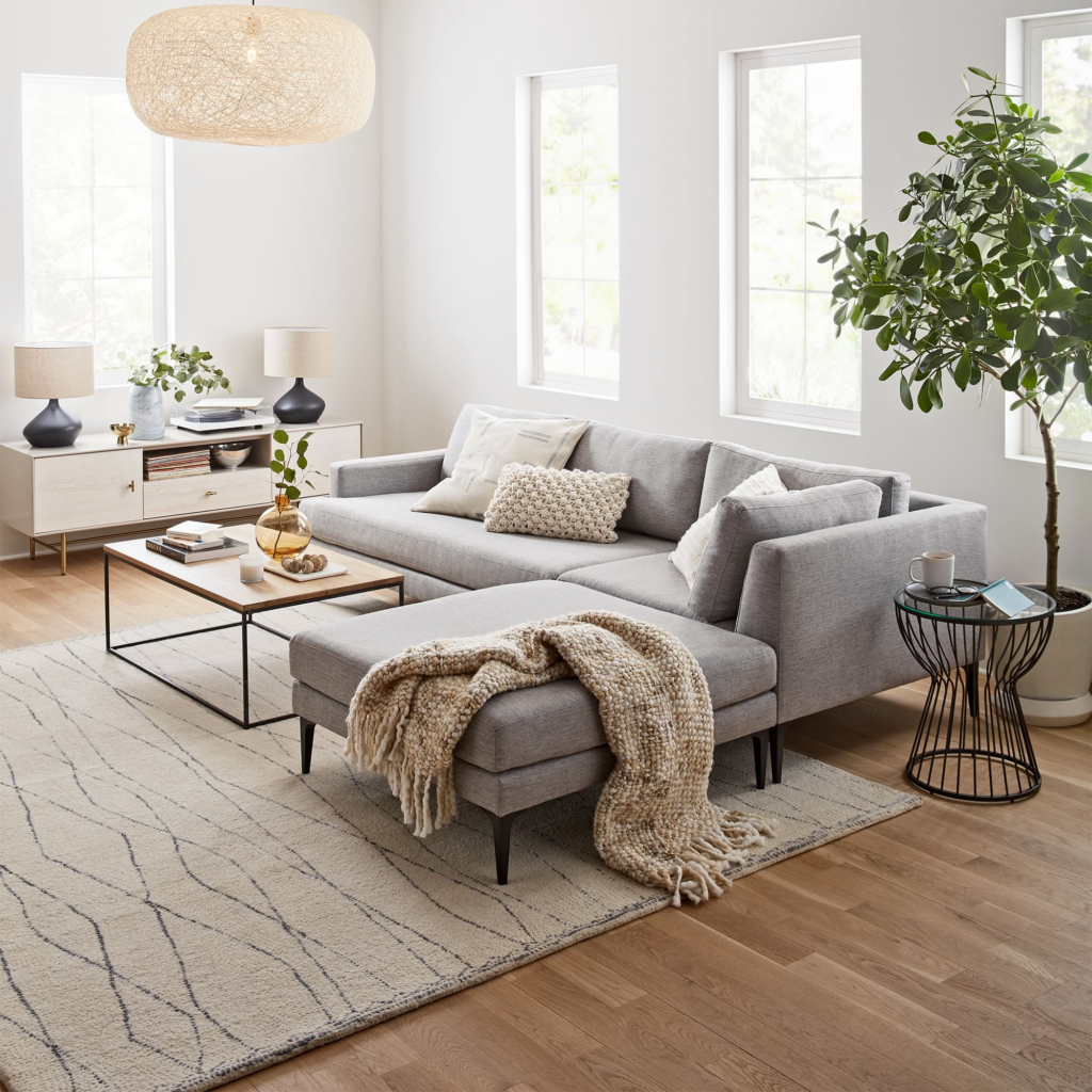 Home Renovation for a wellness driven home. living room from west elm with grey sectional